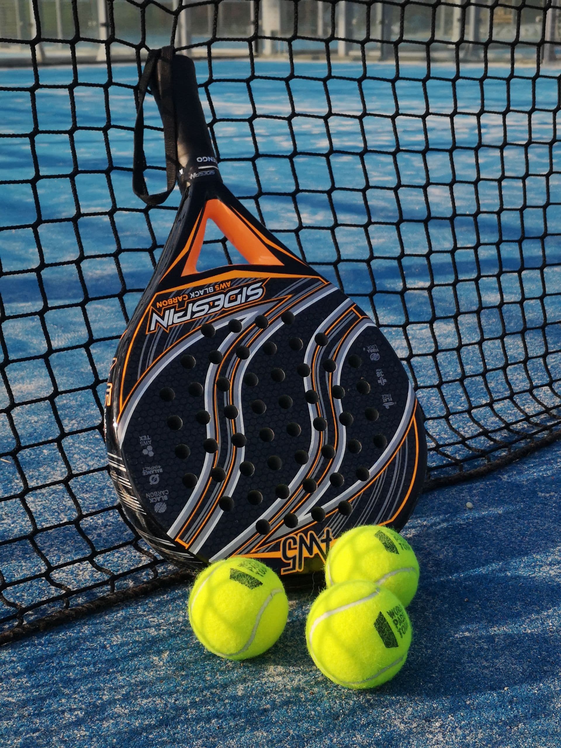 Padel racket and balls on court — illustrative photography